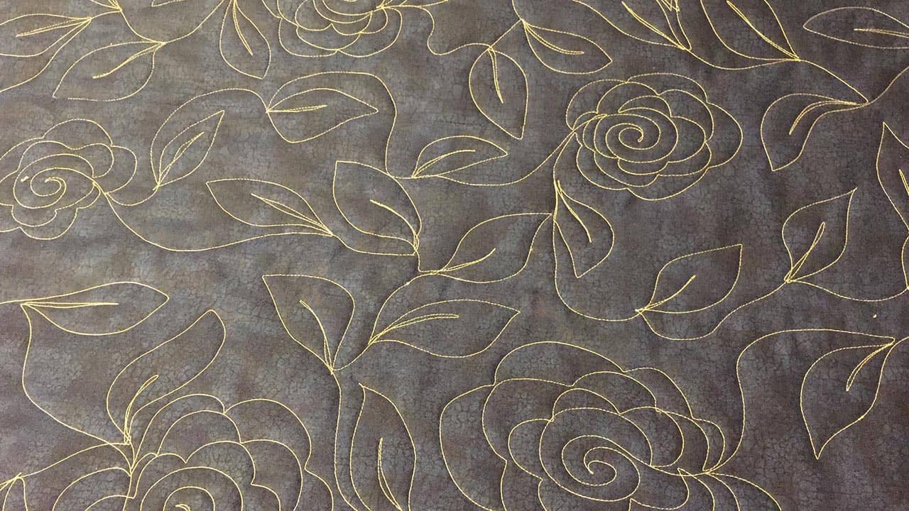 yellow spiral roses and leaves on a gray backing