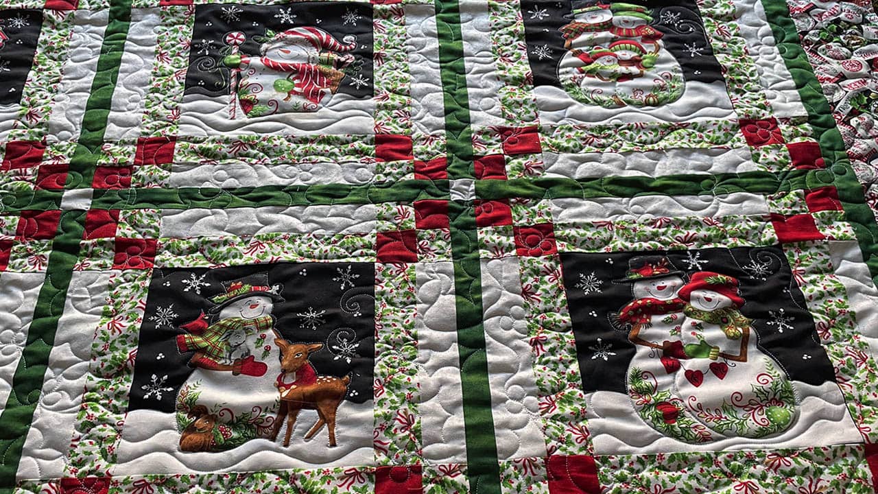 quilting adds depth and texture to a snowman quilt