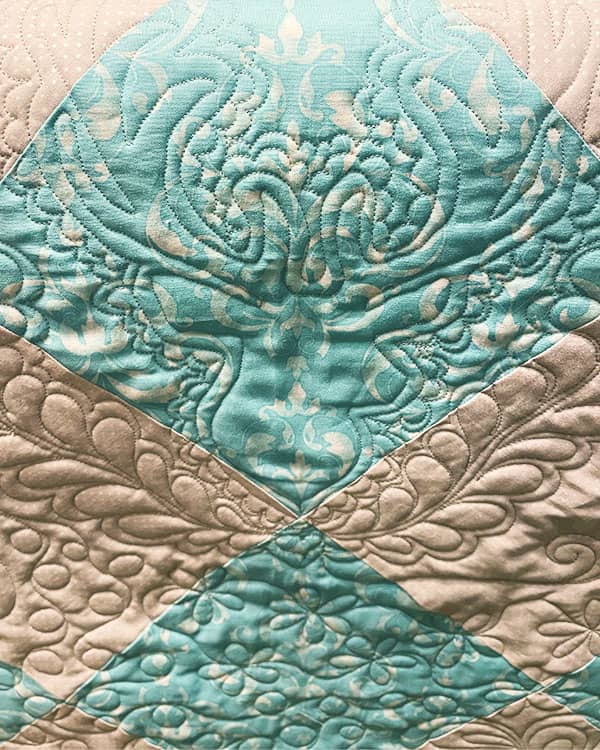 A bold custom long arm quilting design can strongly accent a motif